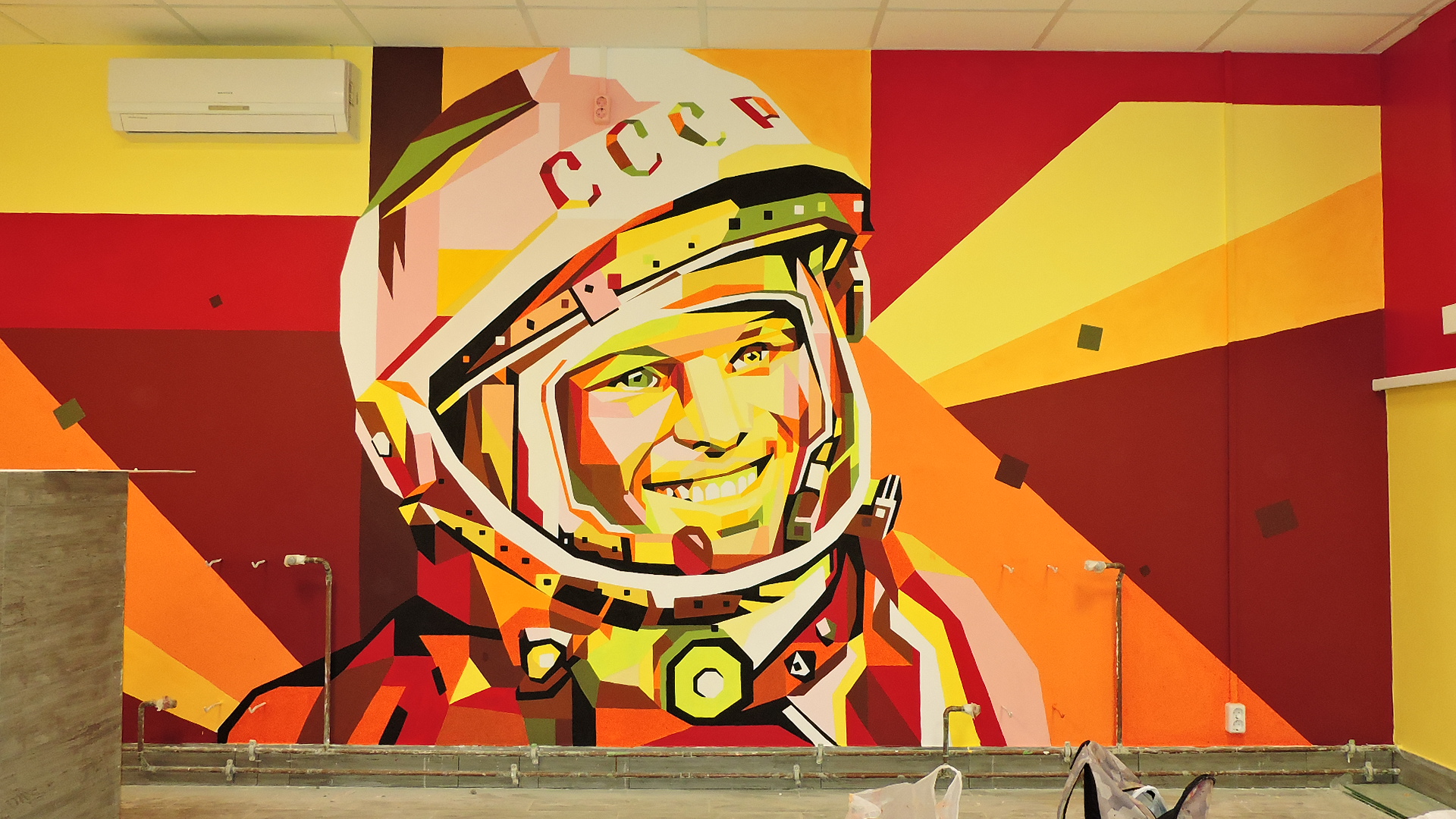 On the wall painted Gagarin's face in a spacesuit